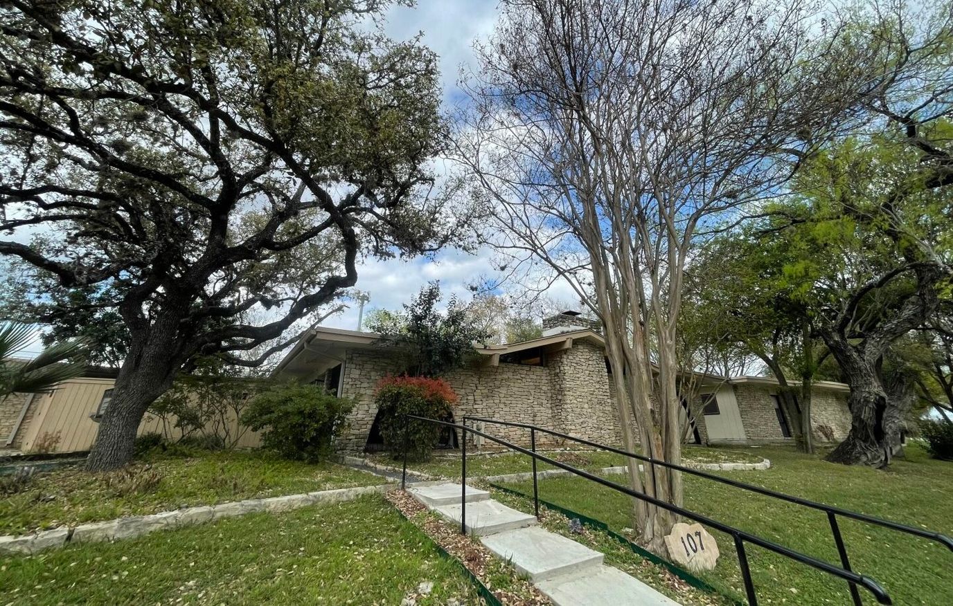 Exterior view of the assisted living facility surrounded by trees
