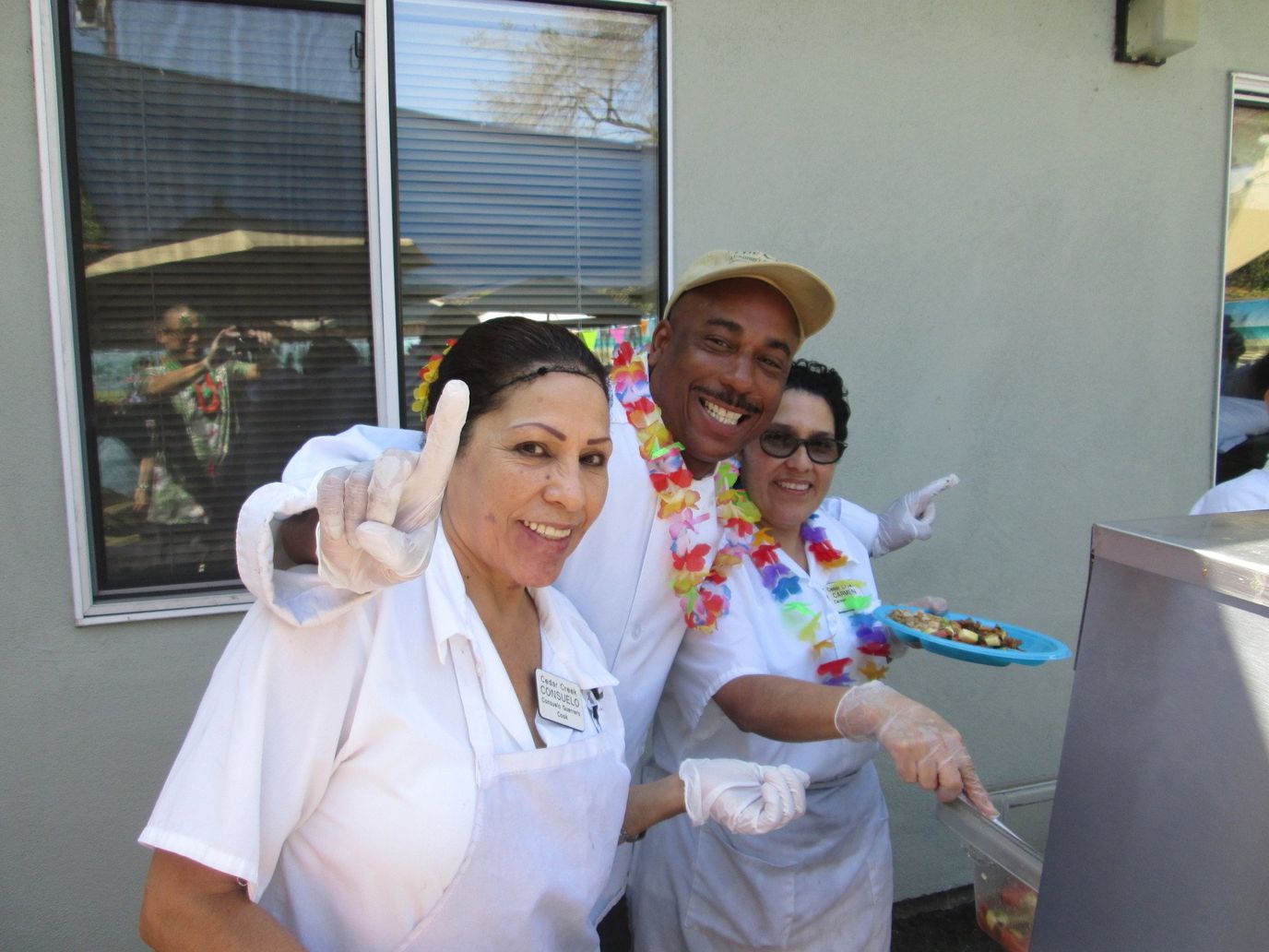 Staff members preparing food in festive attire outside