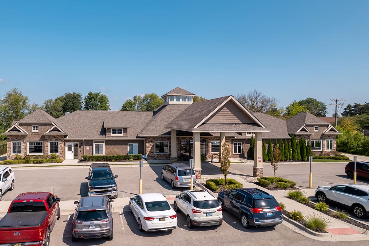 Exterior view of the facility with parked cars.