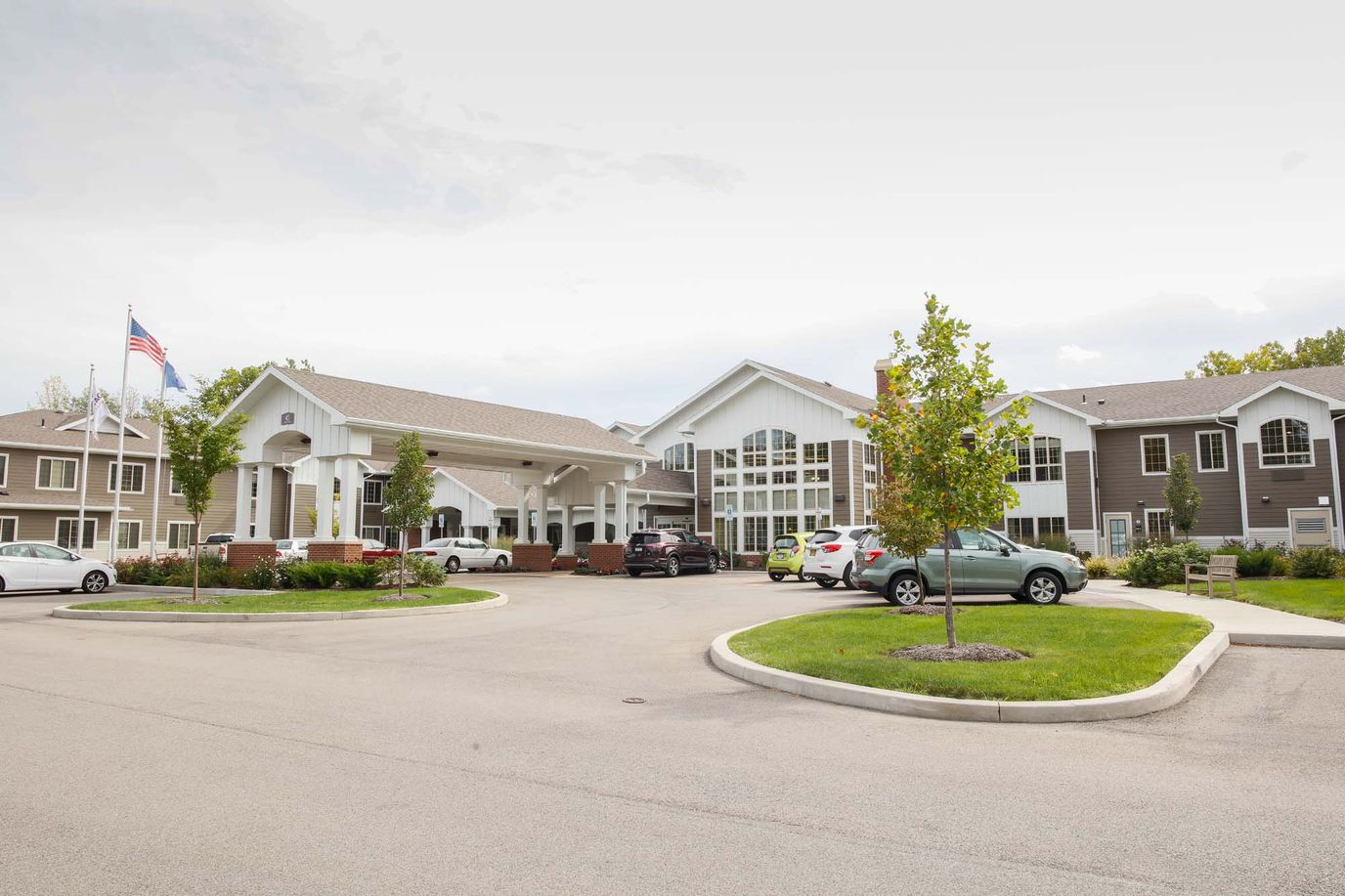 Exterior view of the senior living facility with entrance and landscaping