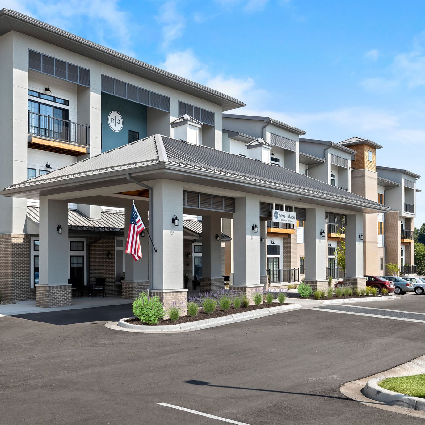 Front entrance of Novel Place Senior Living with American flag