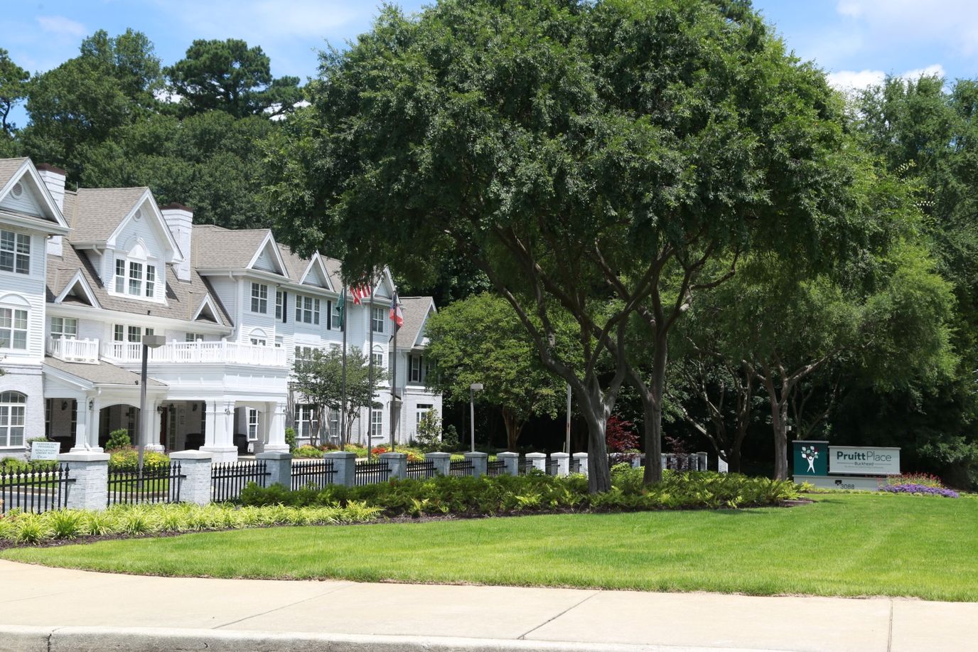 Exterior view of PruittPlace Buckhead with landscaped area
