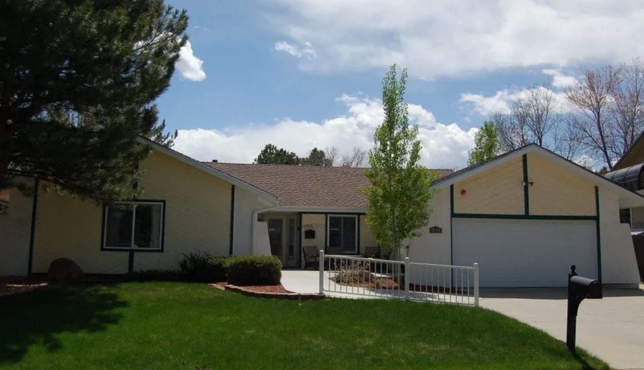 Exterior view of a senior living facility with landscaped grounds