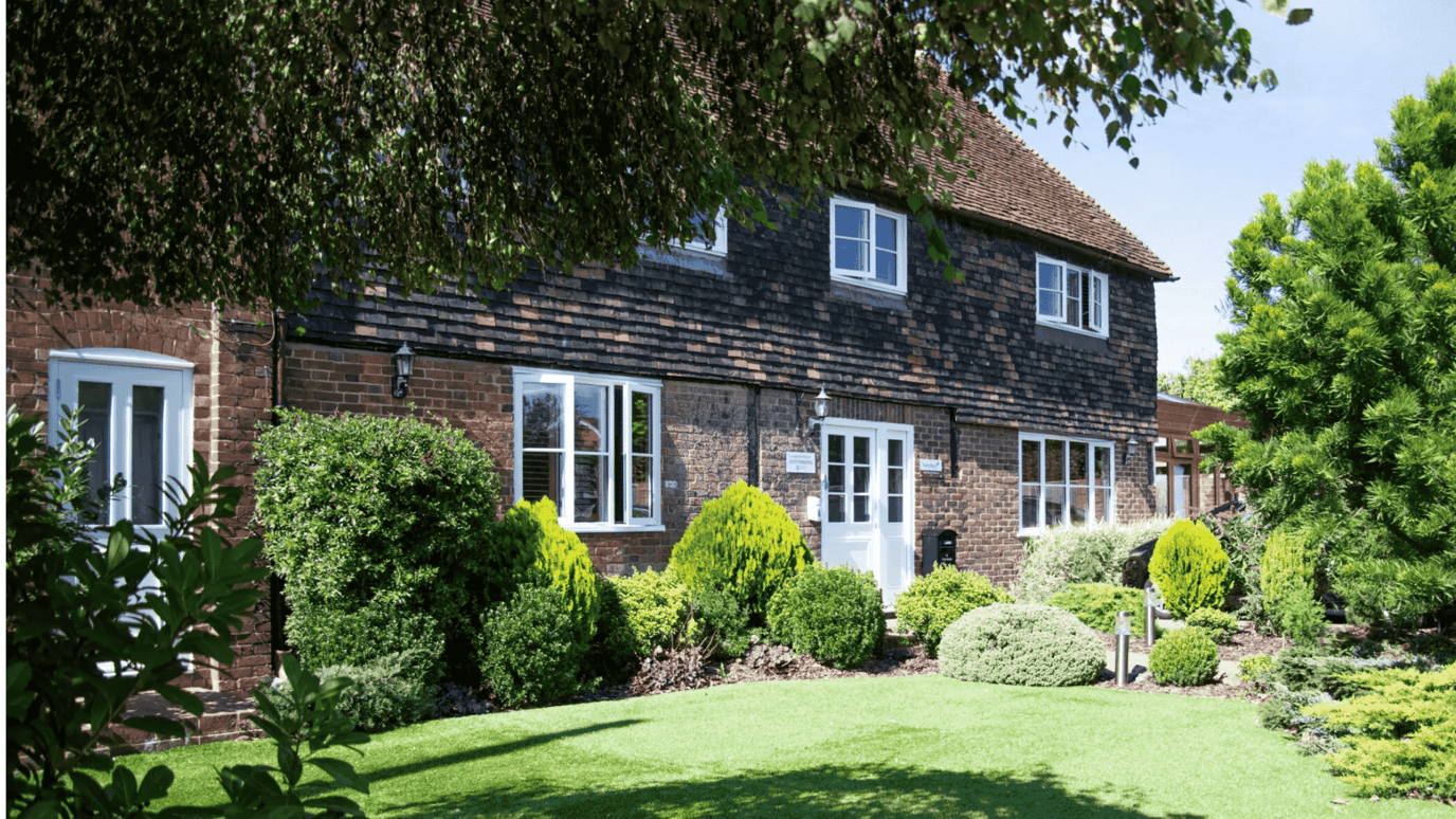Exterior view of a care facility with landscaped gardens.