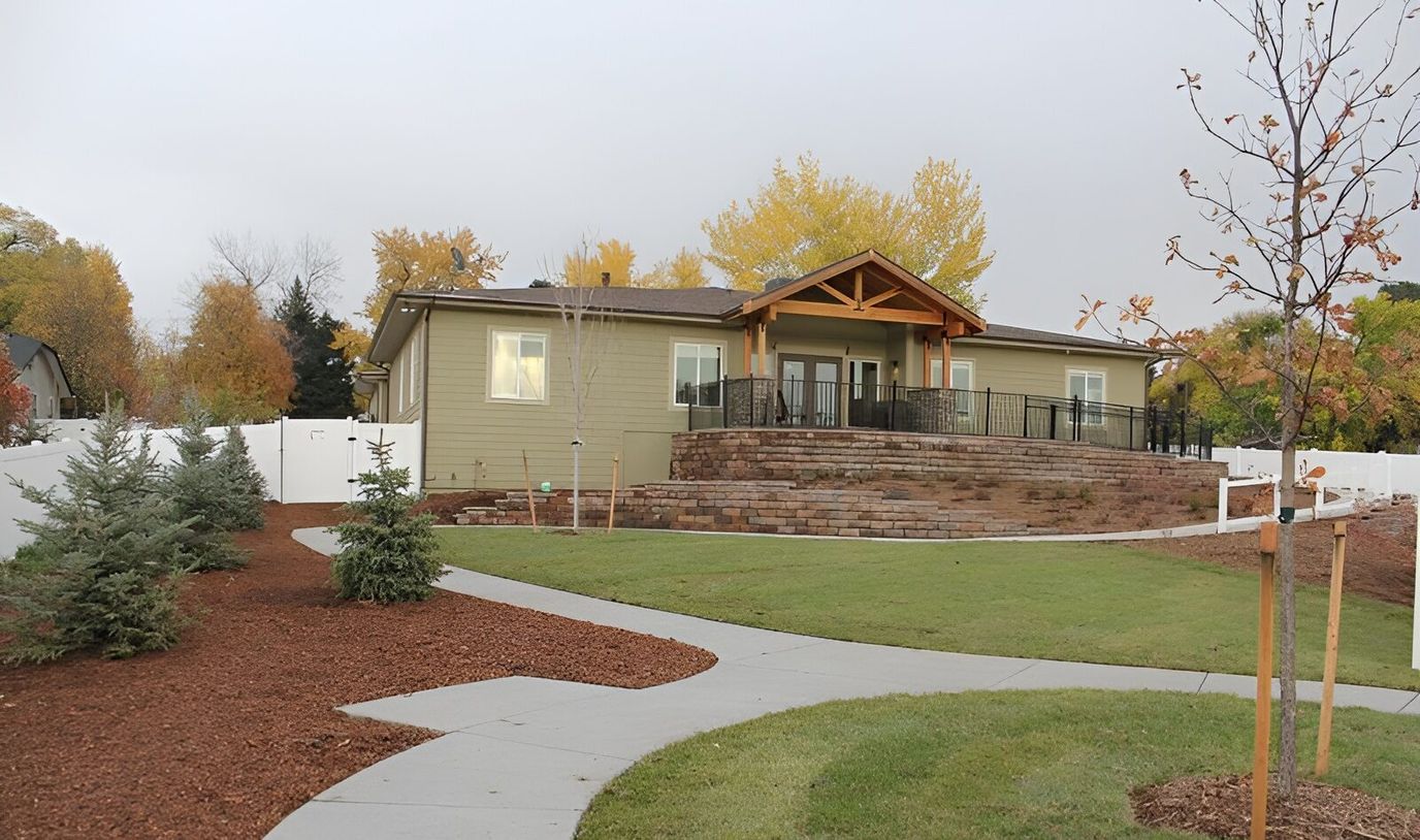 Exterior view of an assisted living facility with landscaped pathways
