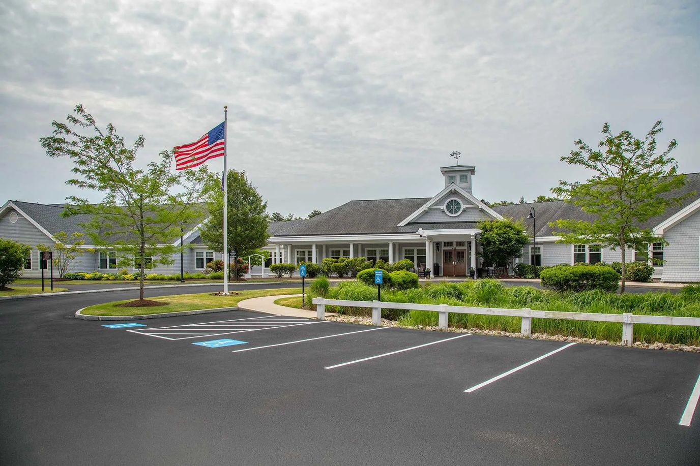 Exterior view of assisted living facility with flag