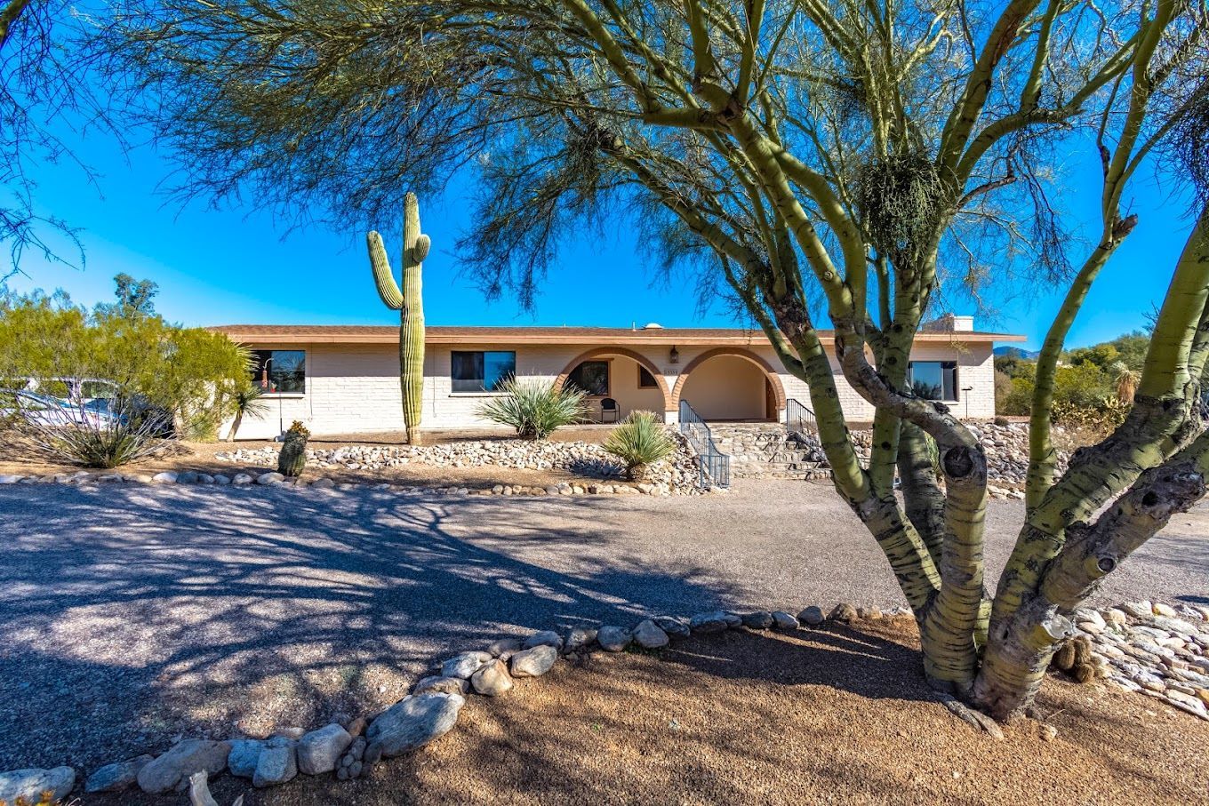 Exterior view of a senior living facility surrounded by desert landscaping