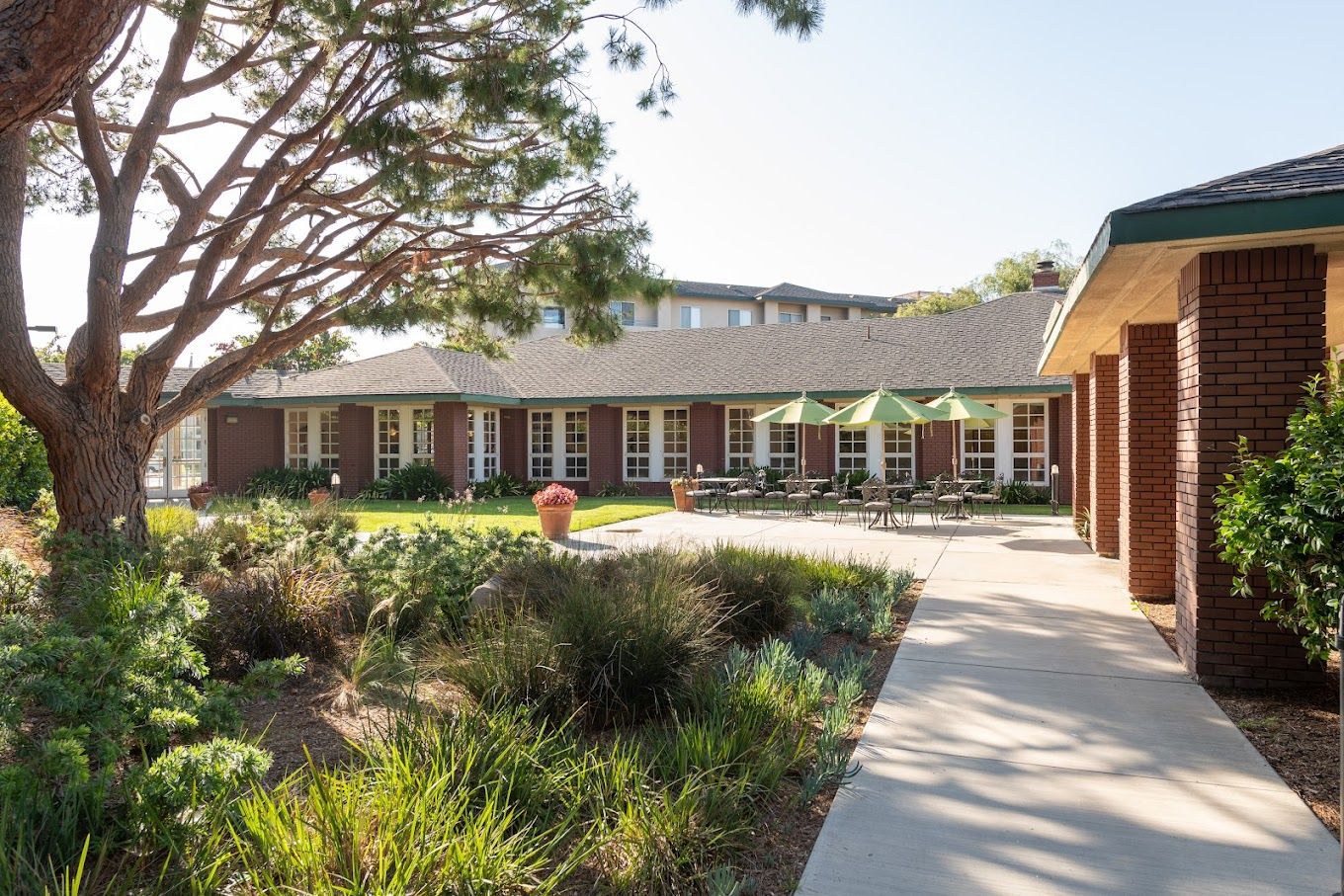 Exterior view of Carmel Village with outdoor seating and landscaping
