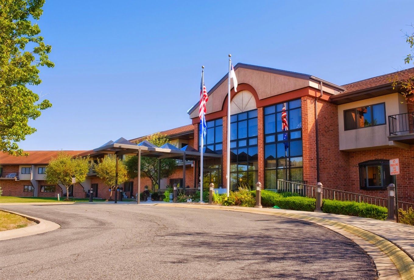 Exterior view of a senior living facility with flags