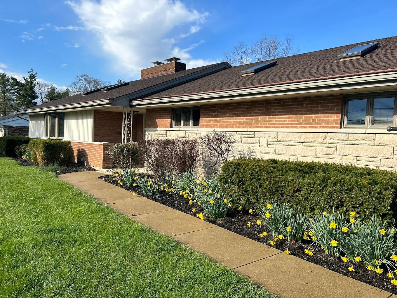 Exterior view of a senior living facility with landscaping