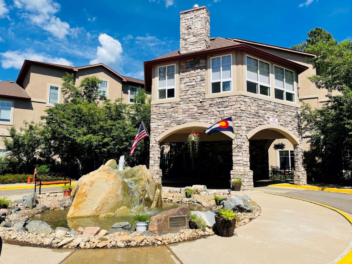 Building entrance with fountain and landscaping