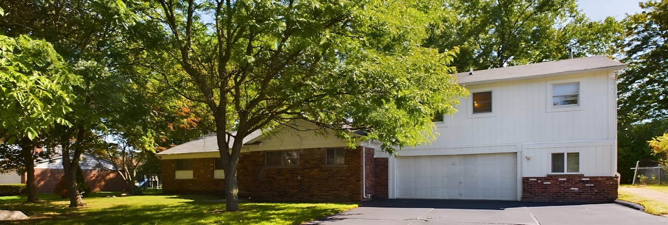 Exterior view of a residential building surrounded by trees