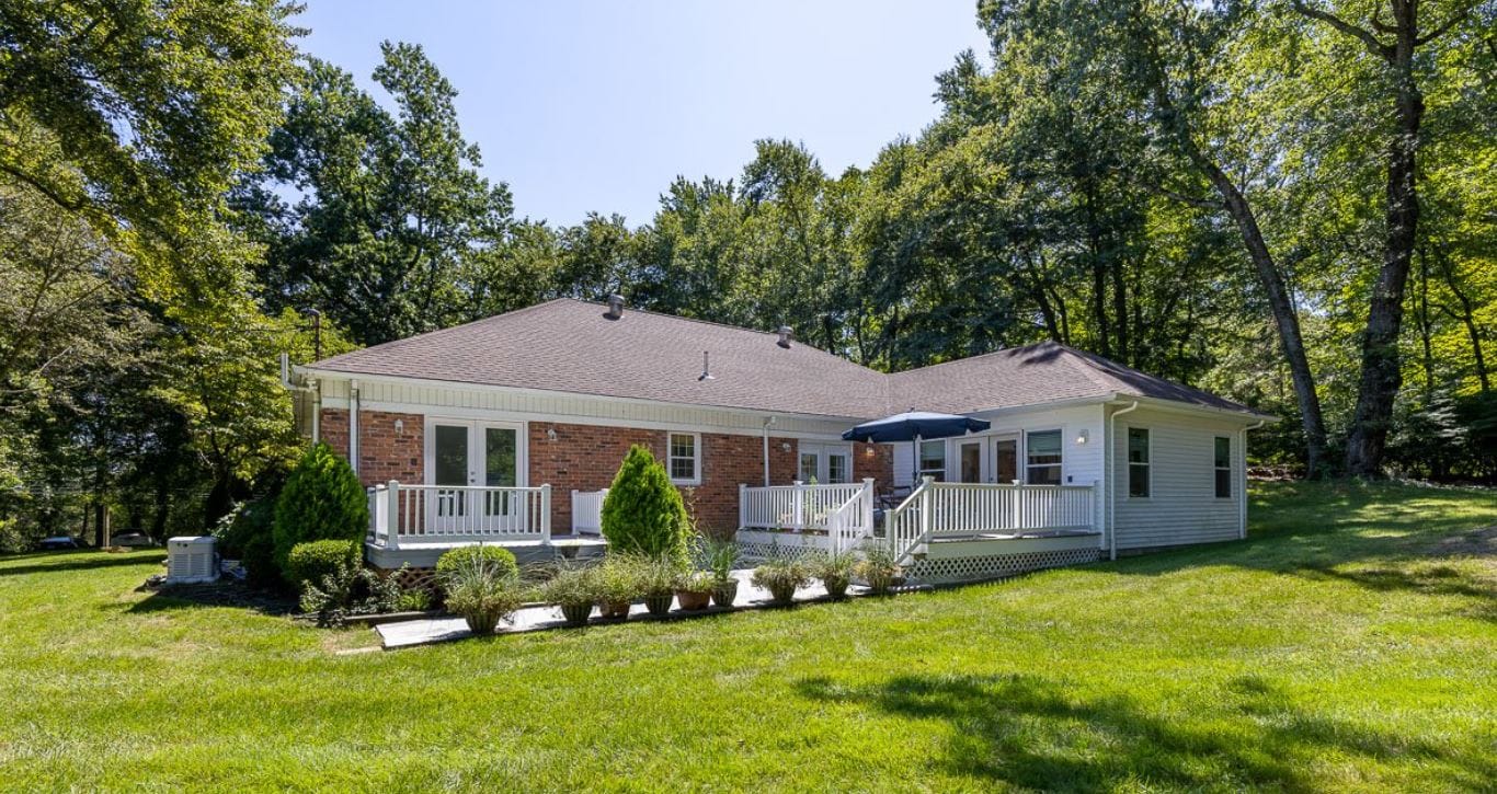 Exterior view of a residential care home surrounded by greenery
