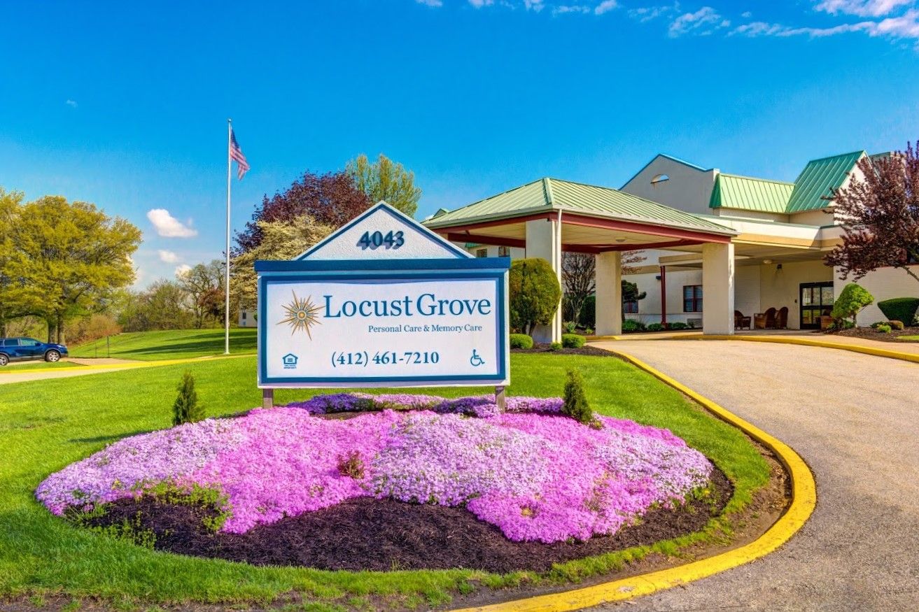 Exterior view of Locust Grove with landscaping and signage