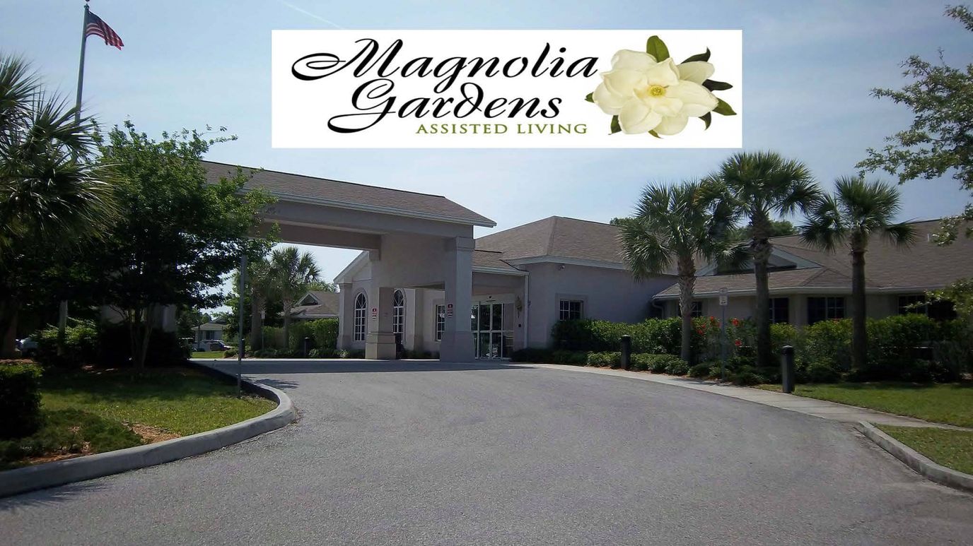 Exterior view of Magnolia Gardens Assisted Living facility with logo