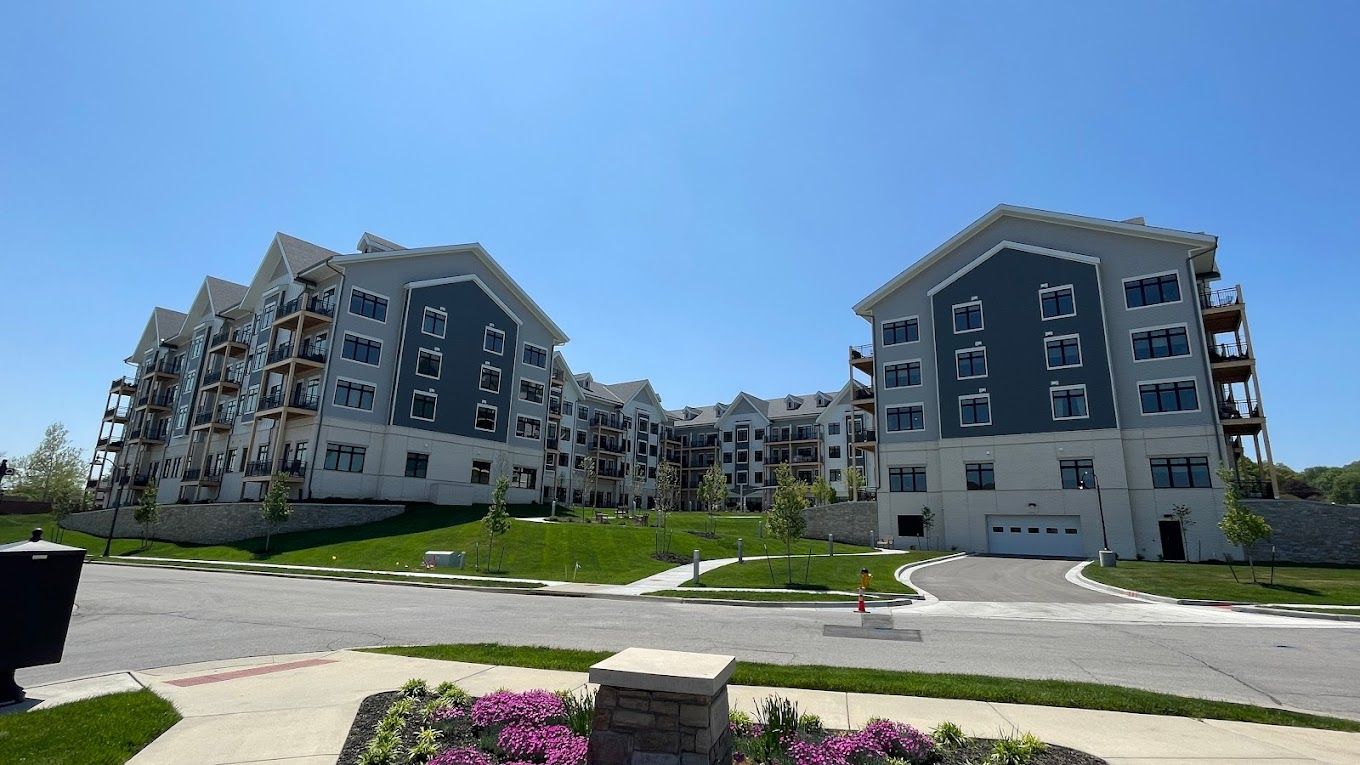 Modern assisted living facility exterior with landscaped grounds