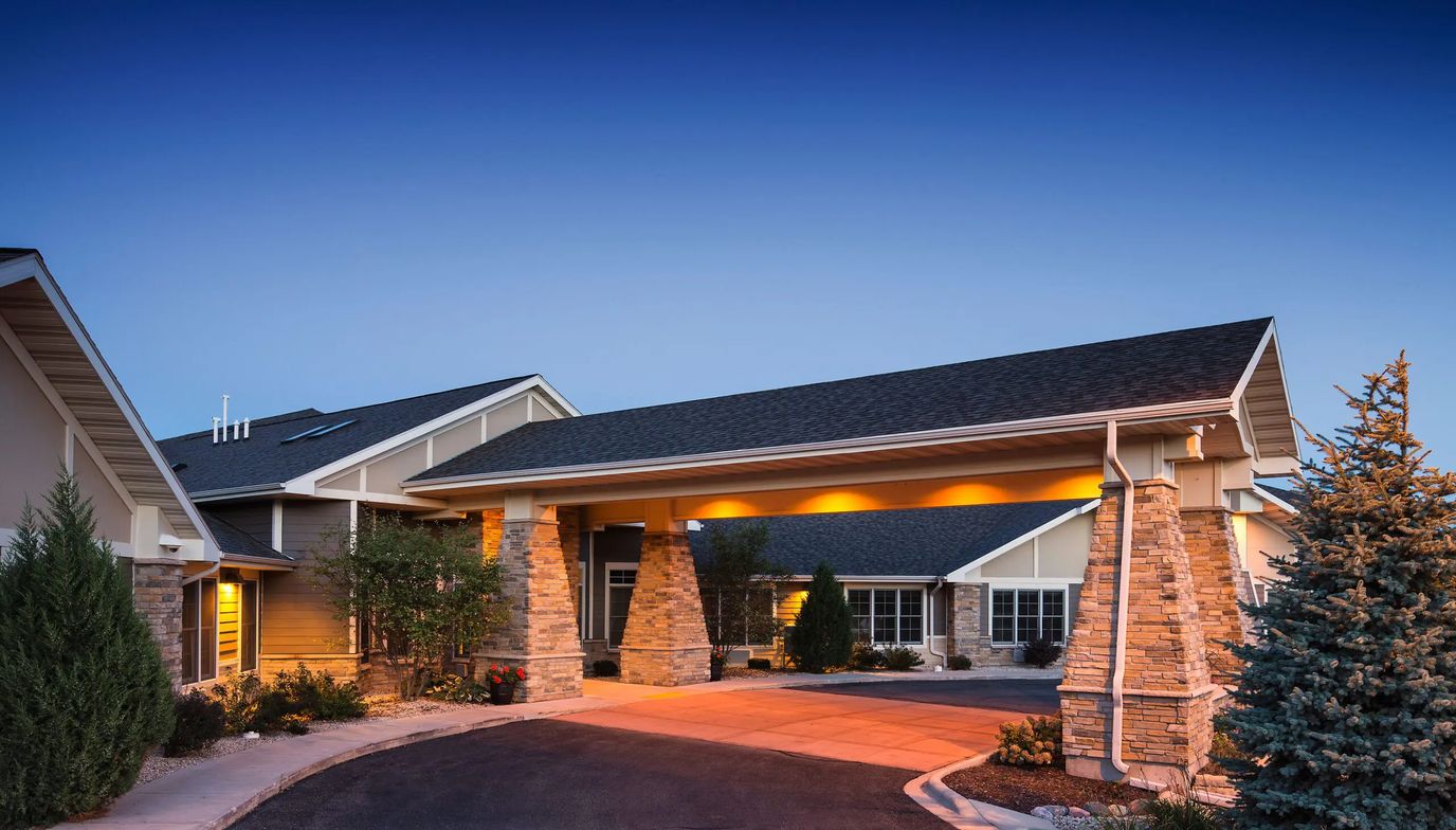 Entrance of Mission Creek Senior Living facility at dusk