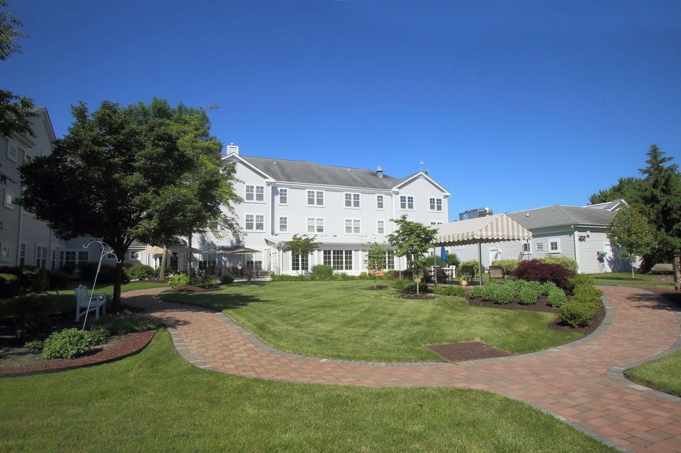 Exterior view of Monmouth Crossing Assisted Living with landscaped garden