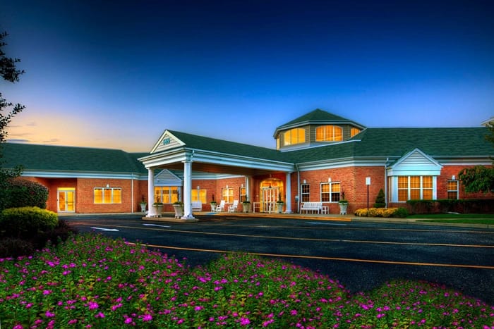 Exterior view of Pines Village with landscaped gardens