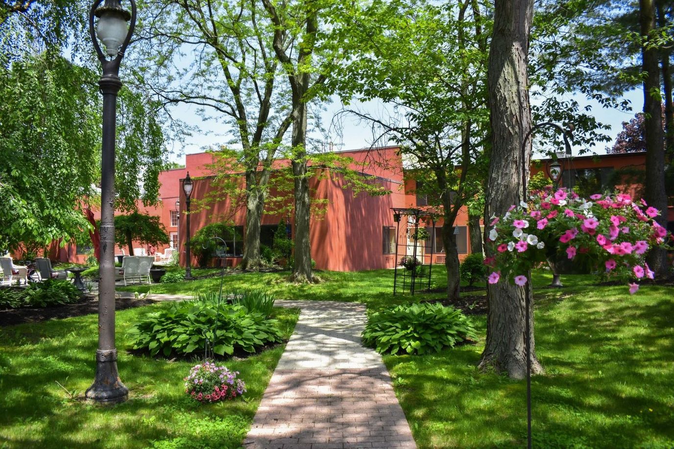 A landscaped path leading to a senior living facility.