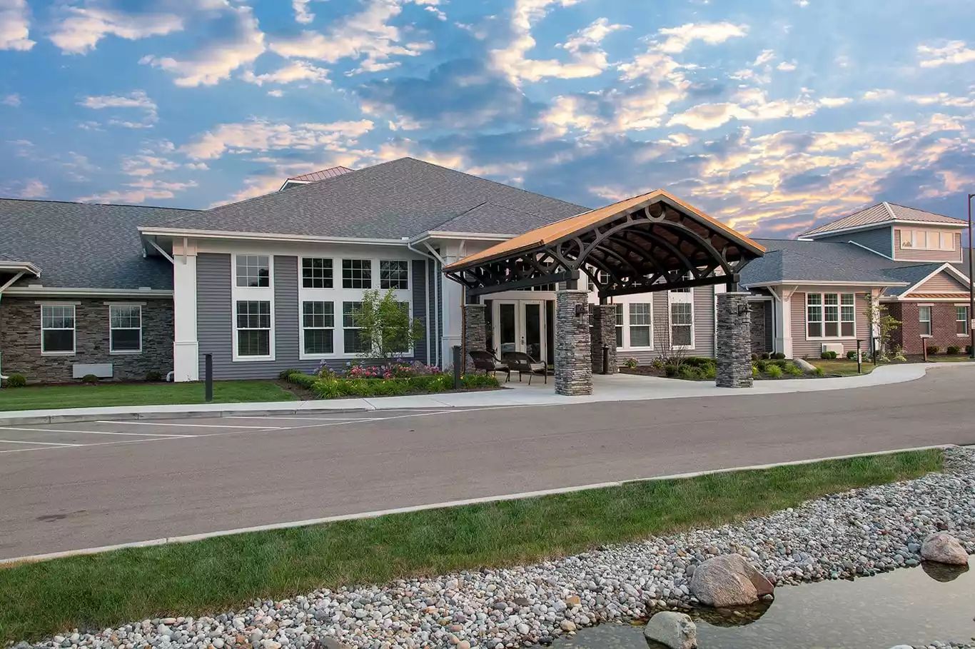 Exterior view of Serene Gardens facility at sunset