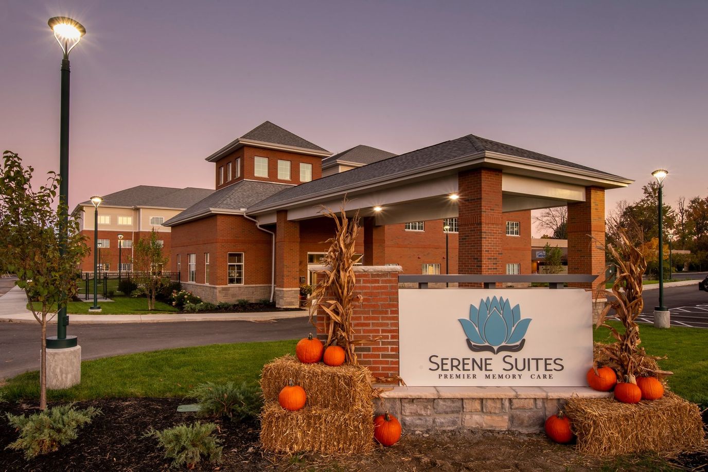 Facility sign with pumpkins in an outdoor setting