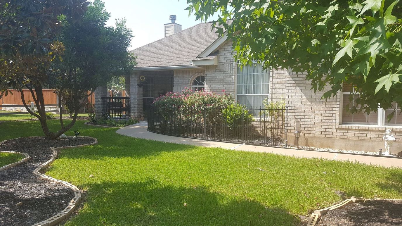 Exterior view of an assisted living facility with garden