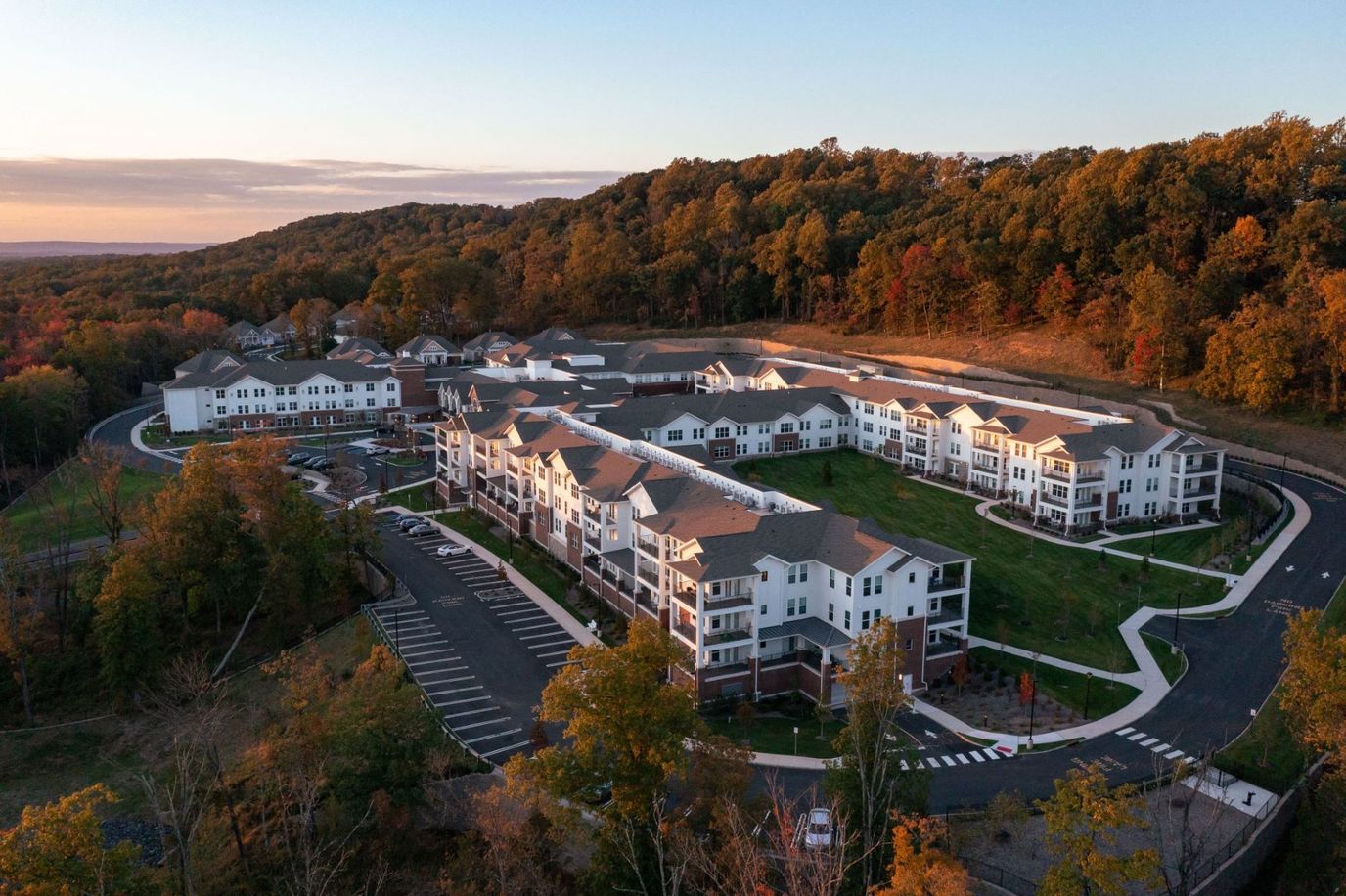 Aerial view of a senior living facility with surrounding nature