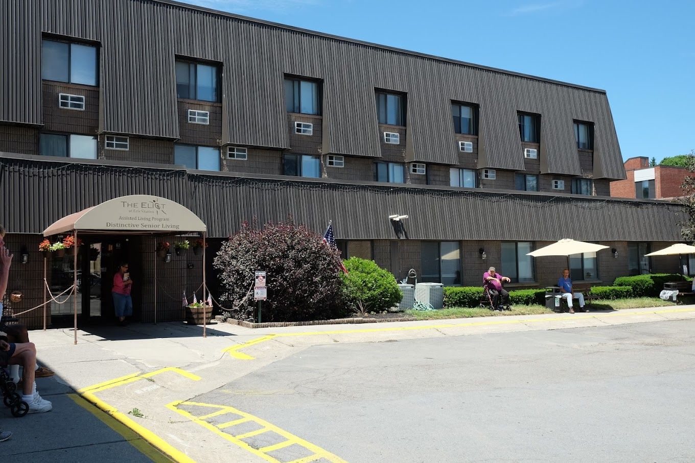 Exterior view of The Eliot Erie Station with residents outside