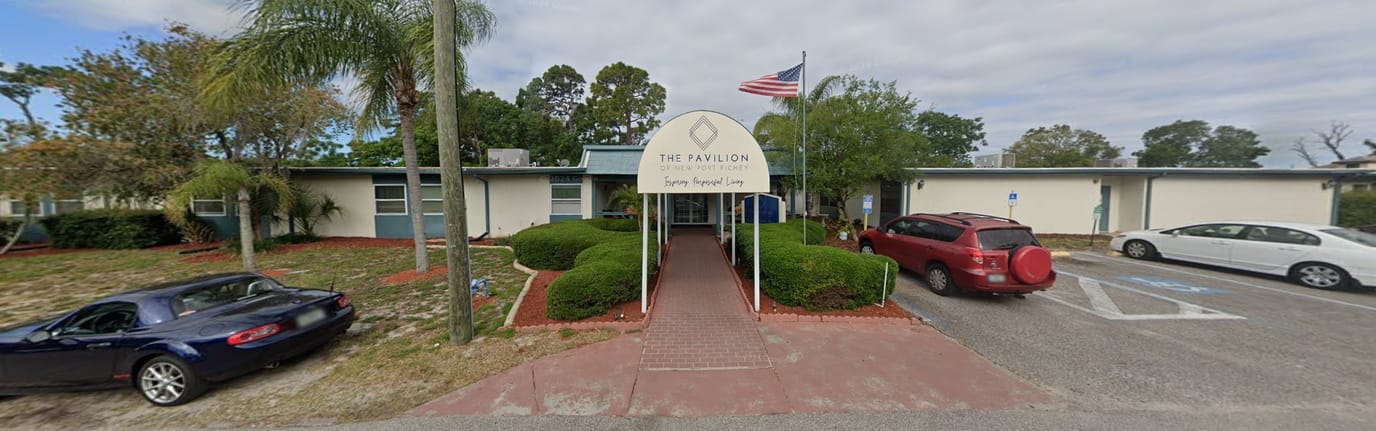 Exterior view of The Pavilion facility with entrance and flag