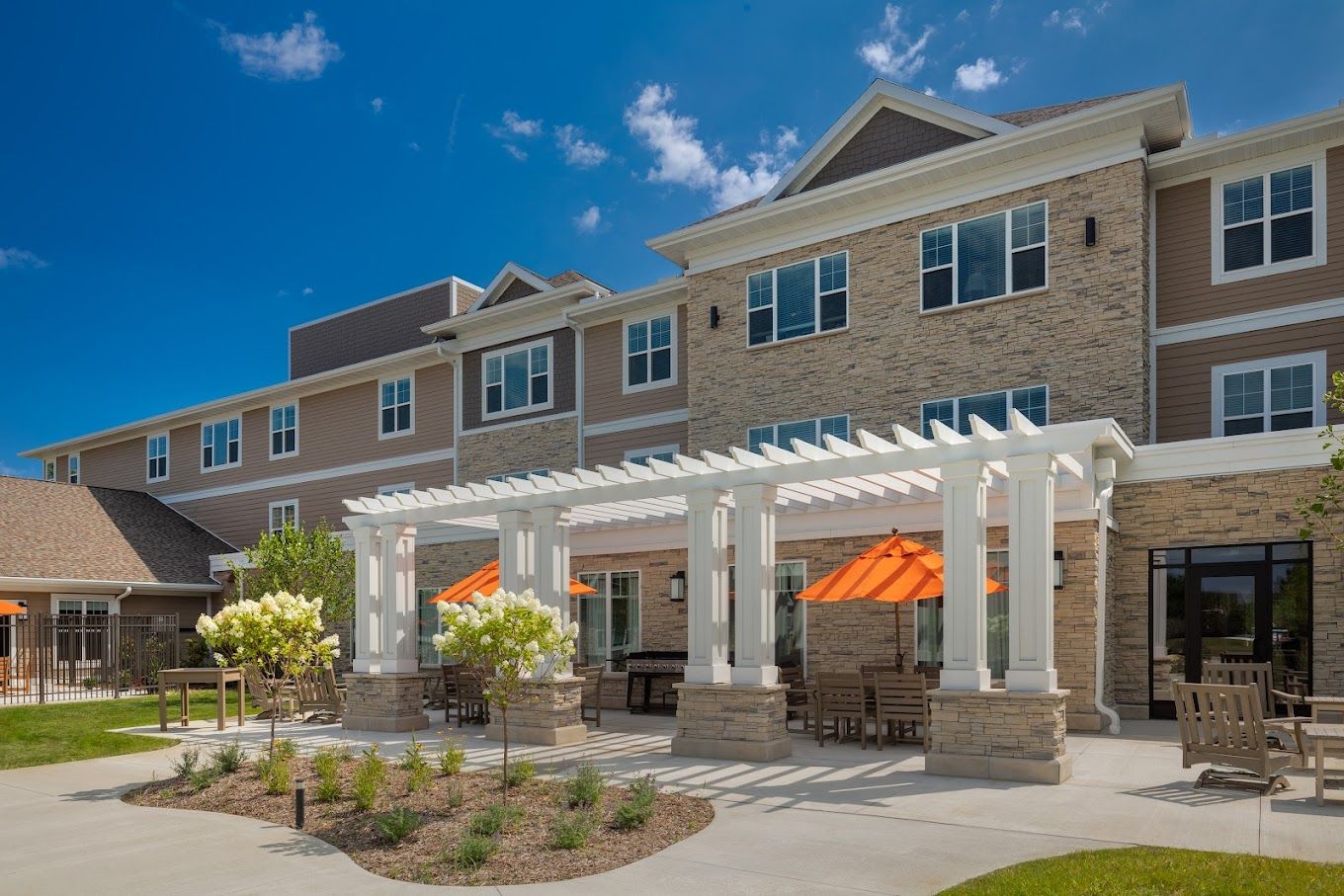 Exterior view of the assisted living facility with outdoor seating