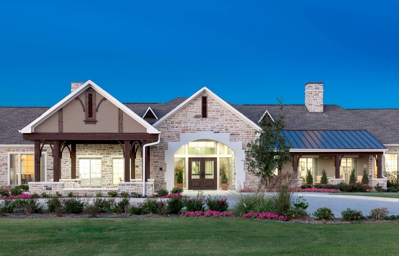 Exterior view of a senior living facility with landscaping