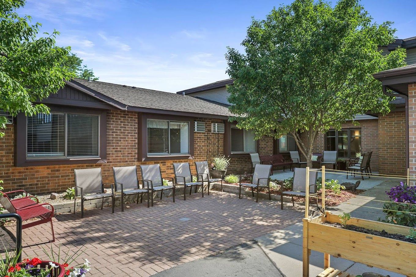 A peaceful outdoor courtyard with seating and greenery