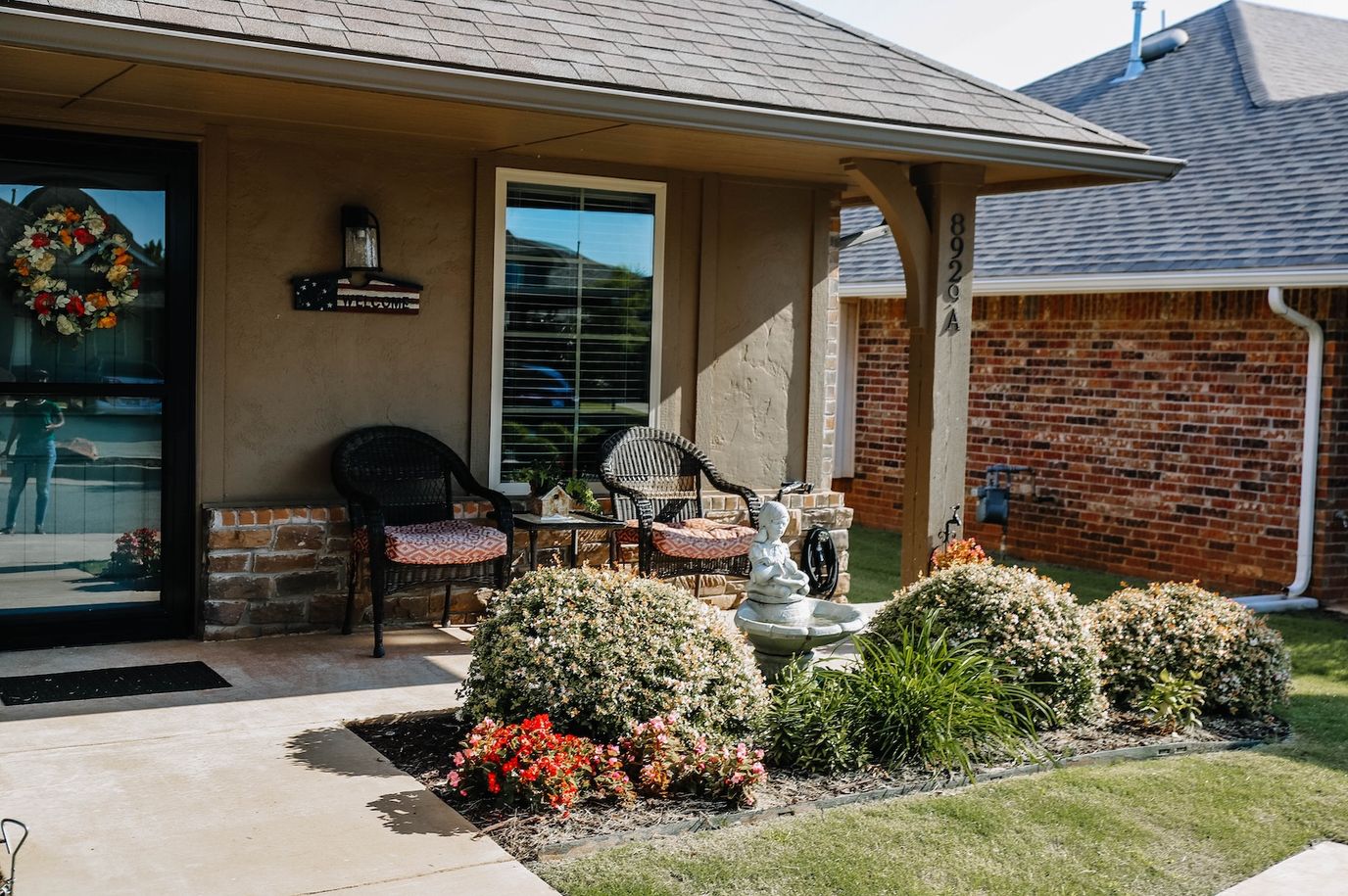 Front porch area with flowers and seating