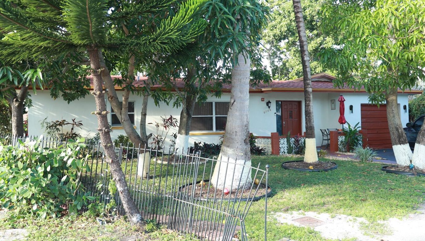 Exterior view of a senior living facility with gardens