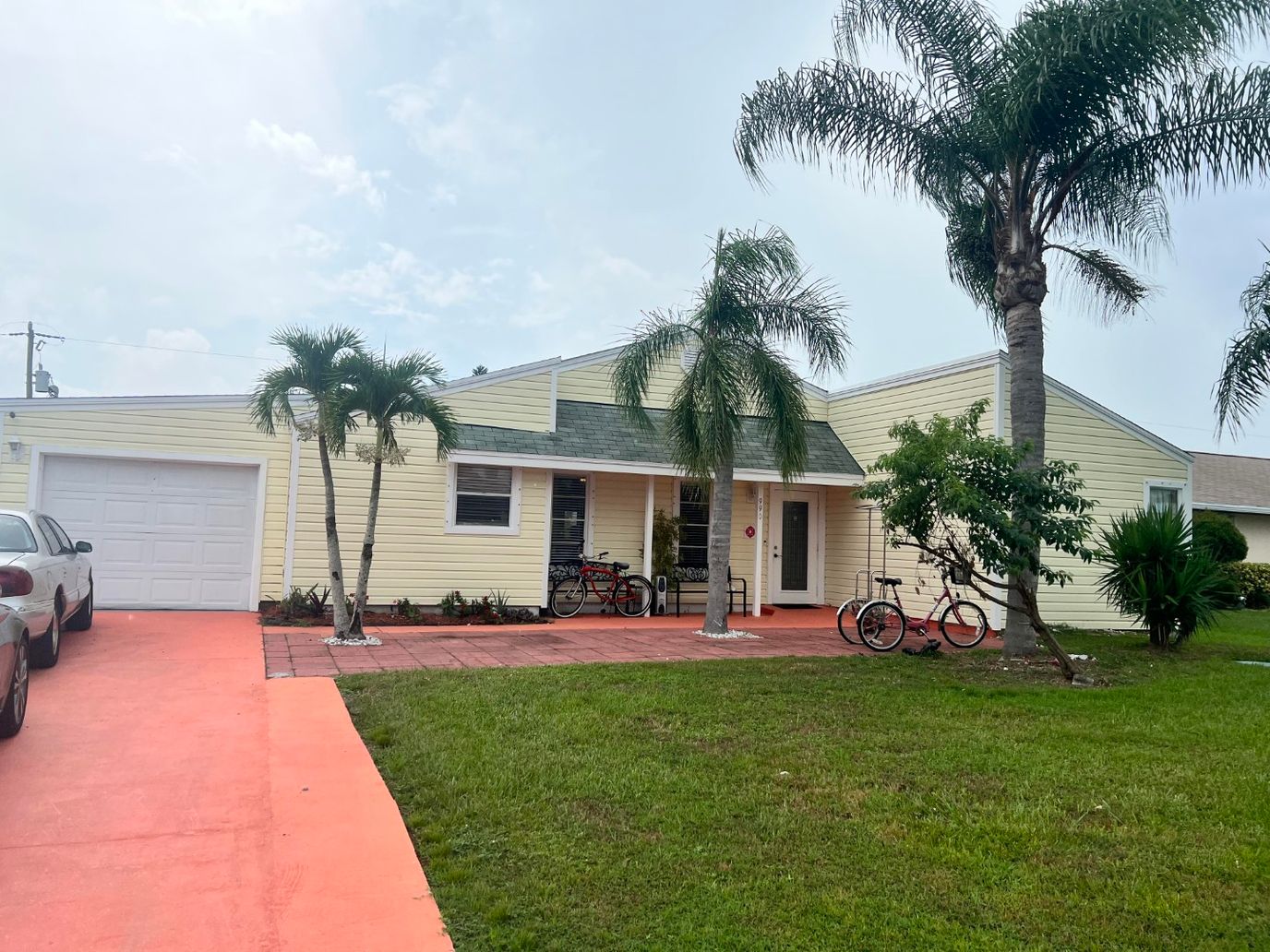 Exterior view of a senior living facility with palm trees