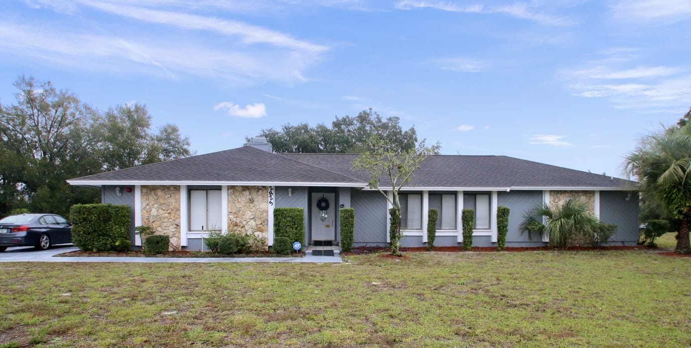 Exterior view of a senior care facility with landscaped lawn