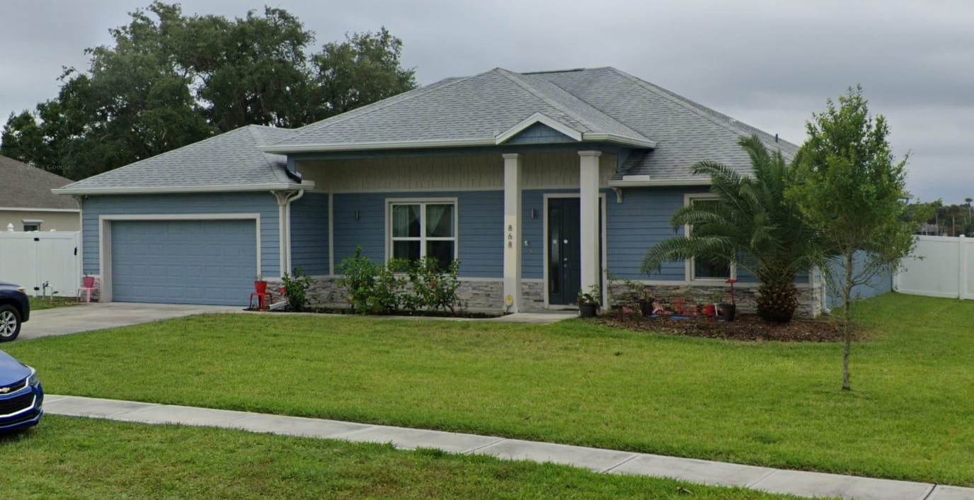 Exterior view of a residential facility with lawn