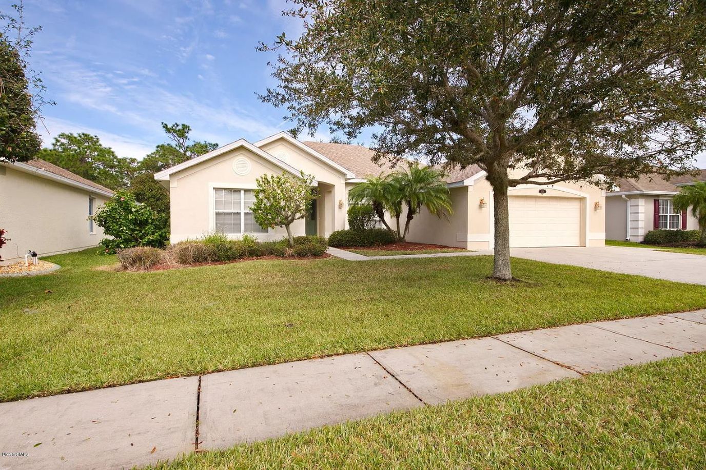 Exterior view of a single-family home with landscaping