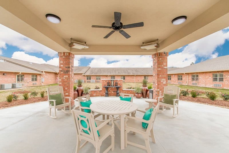 Outdoor patio area with seating and landscaping