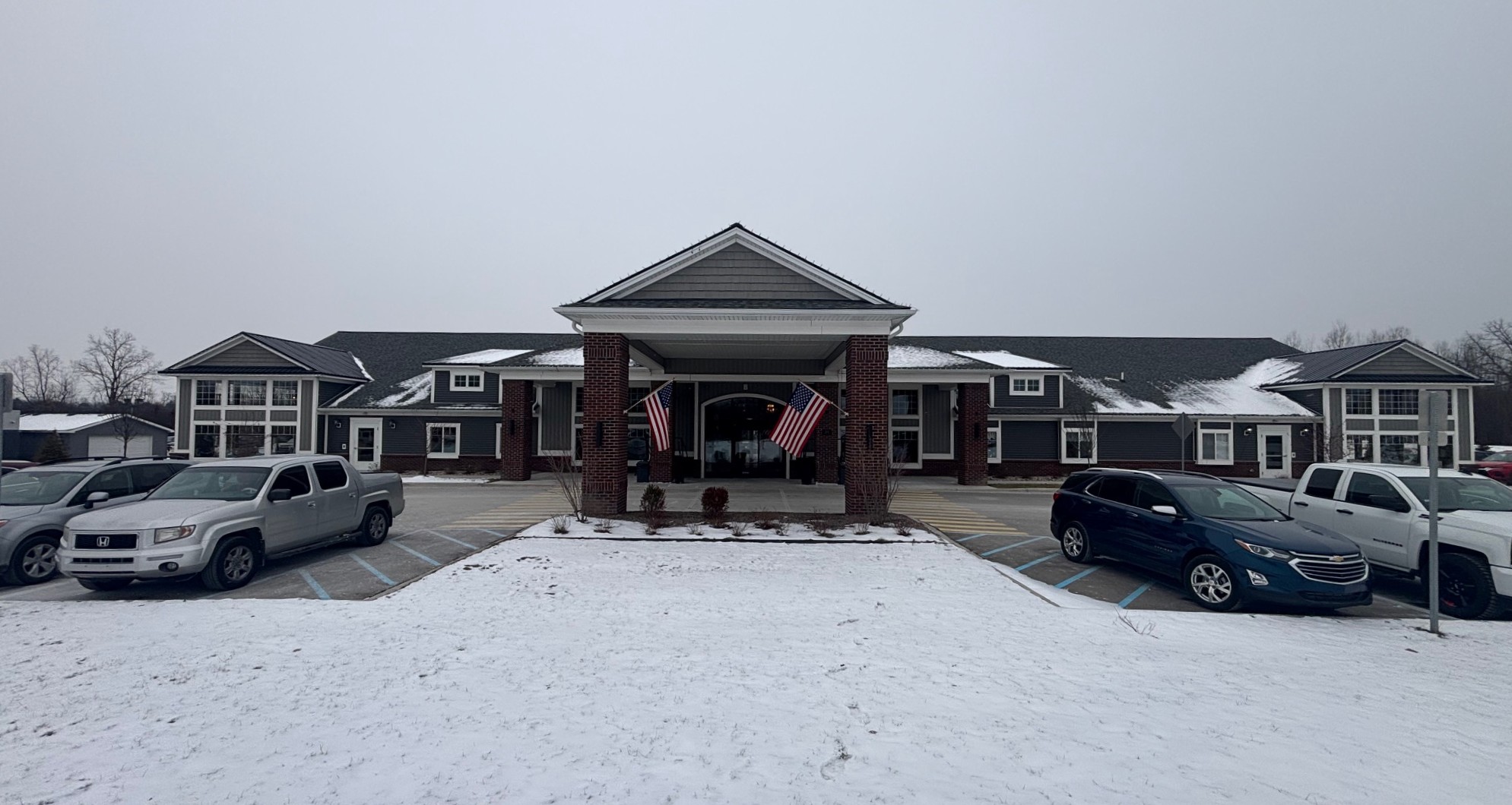 Exterior view of Hampton Manor with snowy parking lot