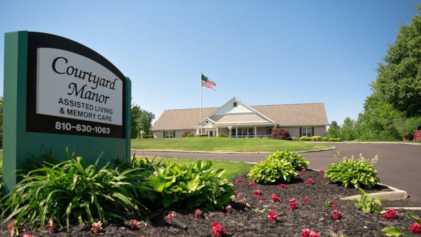 Exterior view of Courtyard Manor building and landscaping