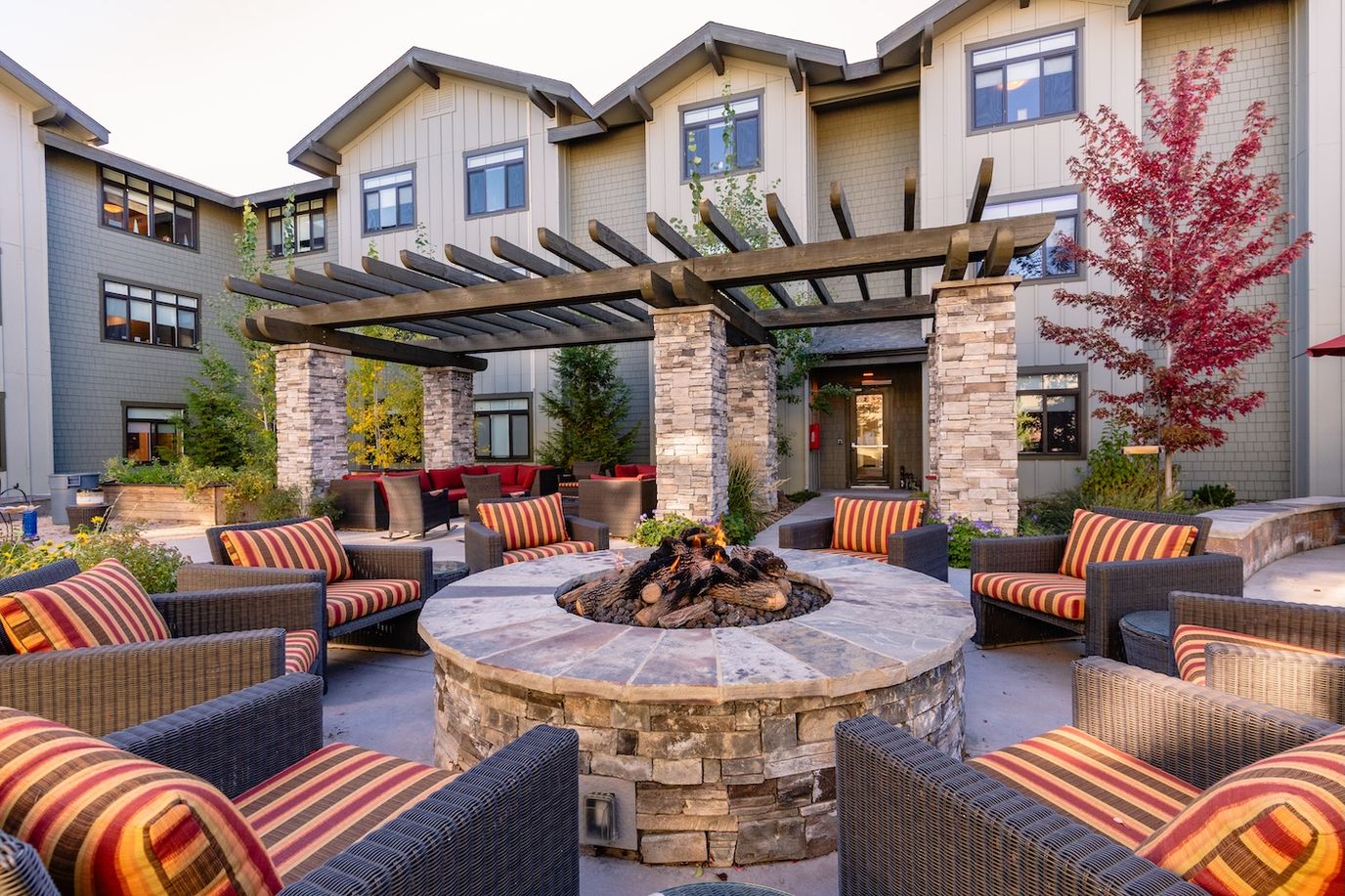 Outdoor seating area with fire pit and landscaped surroundings