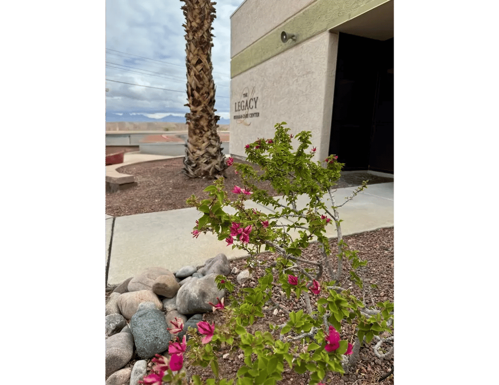 Exterior view of Legacy Rehab and Care Center with flowers