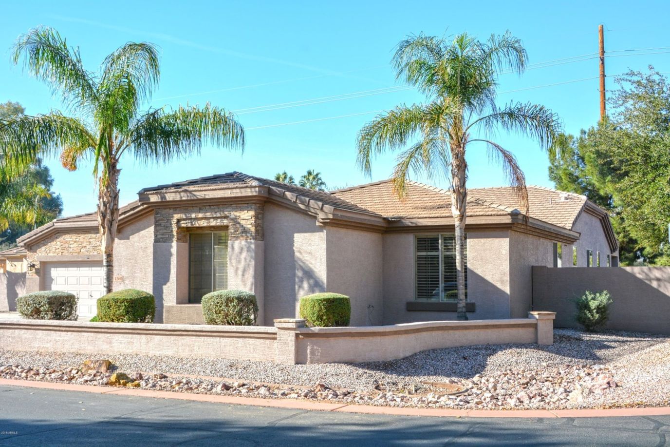 Exterior view of a care home with palm trees