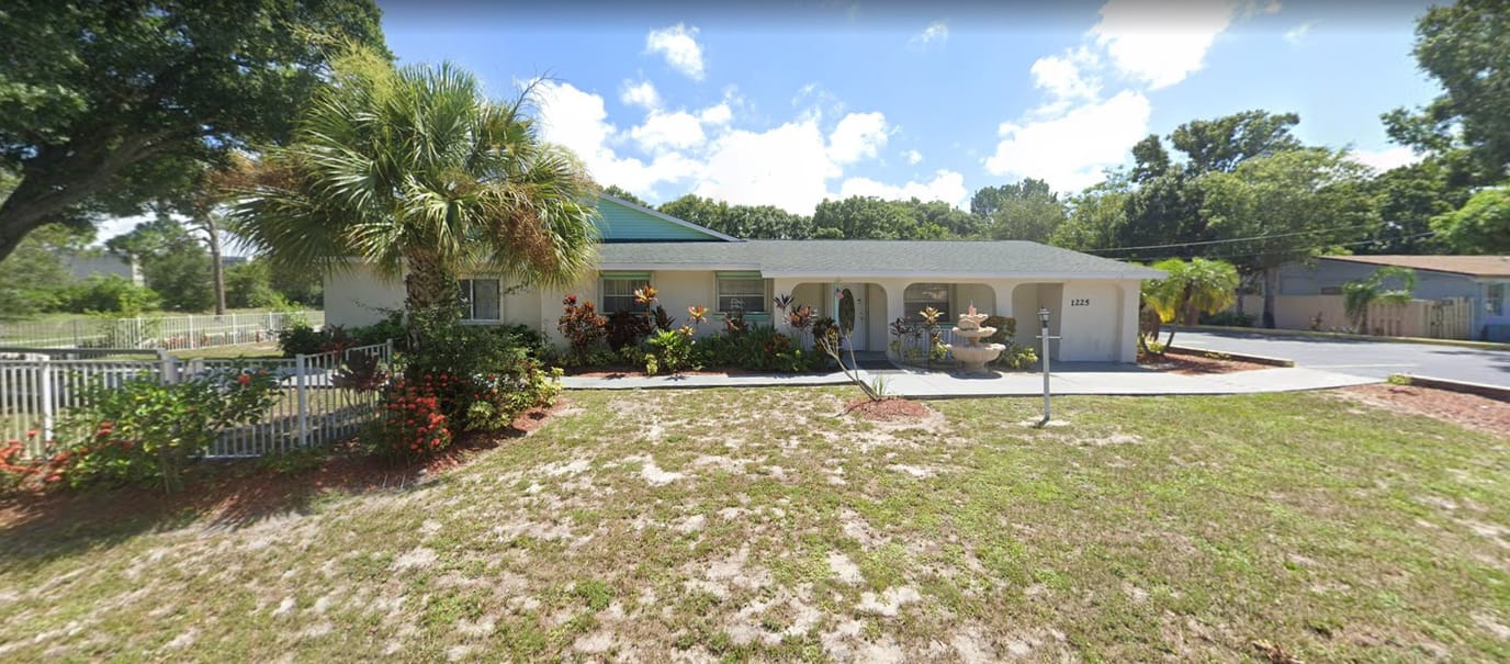 Exterior view of an assisted living facility with garden