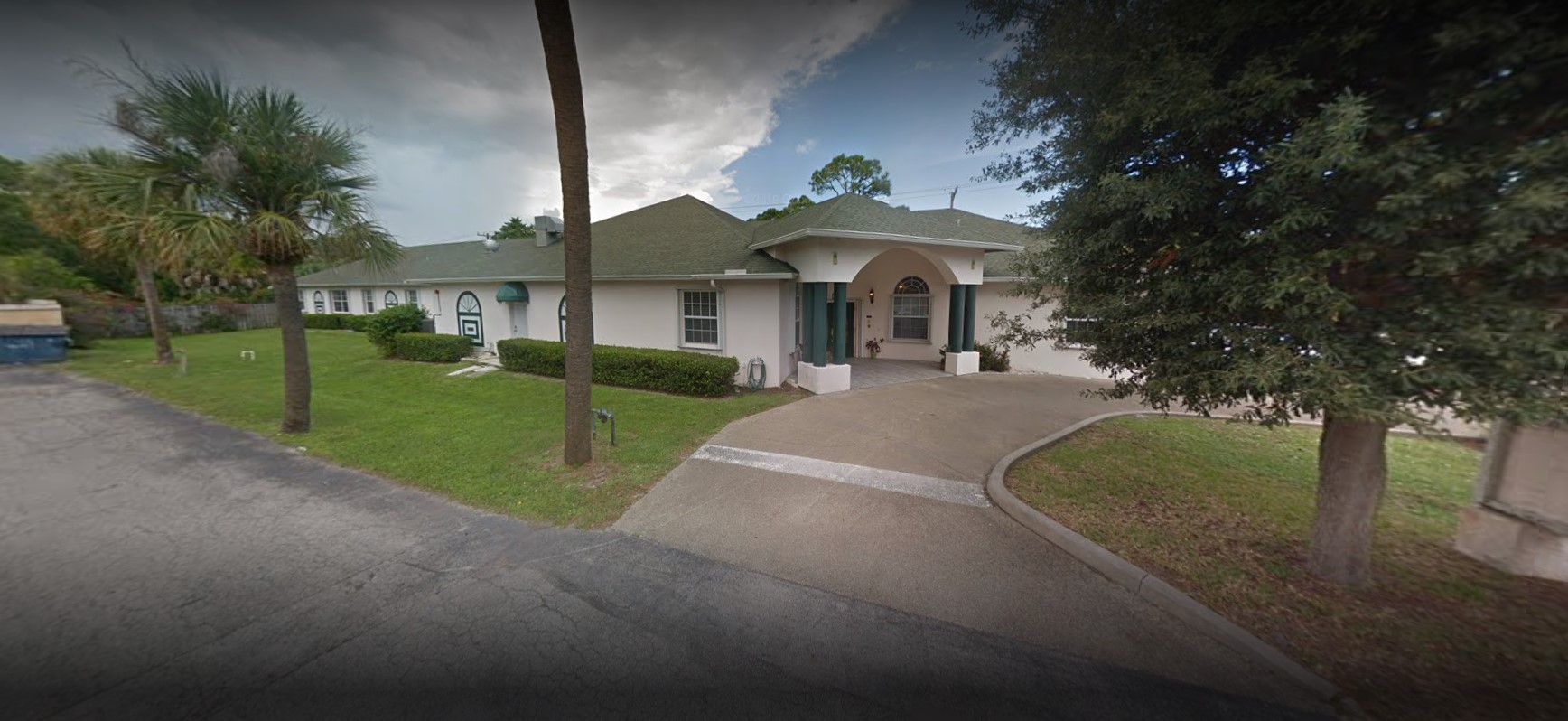Exterior view of a senior care facility with green landscaping