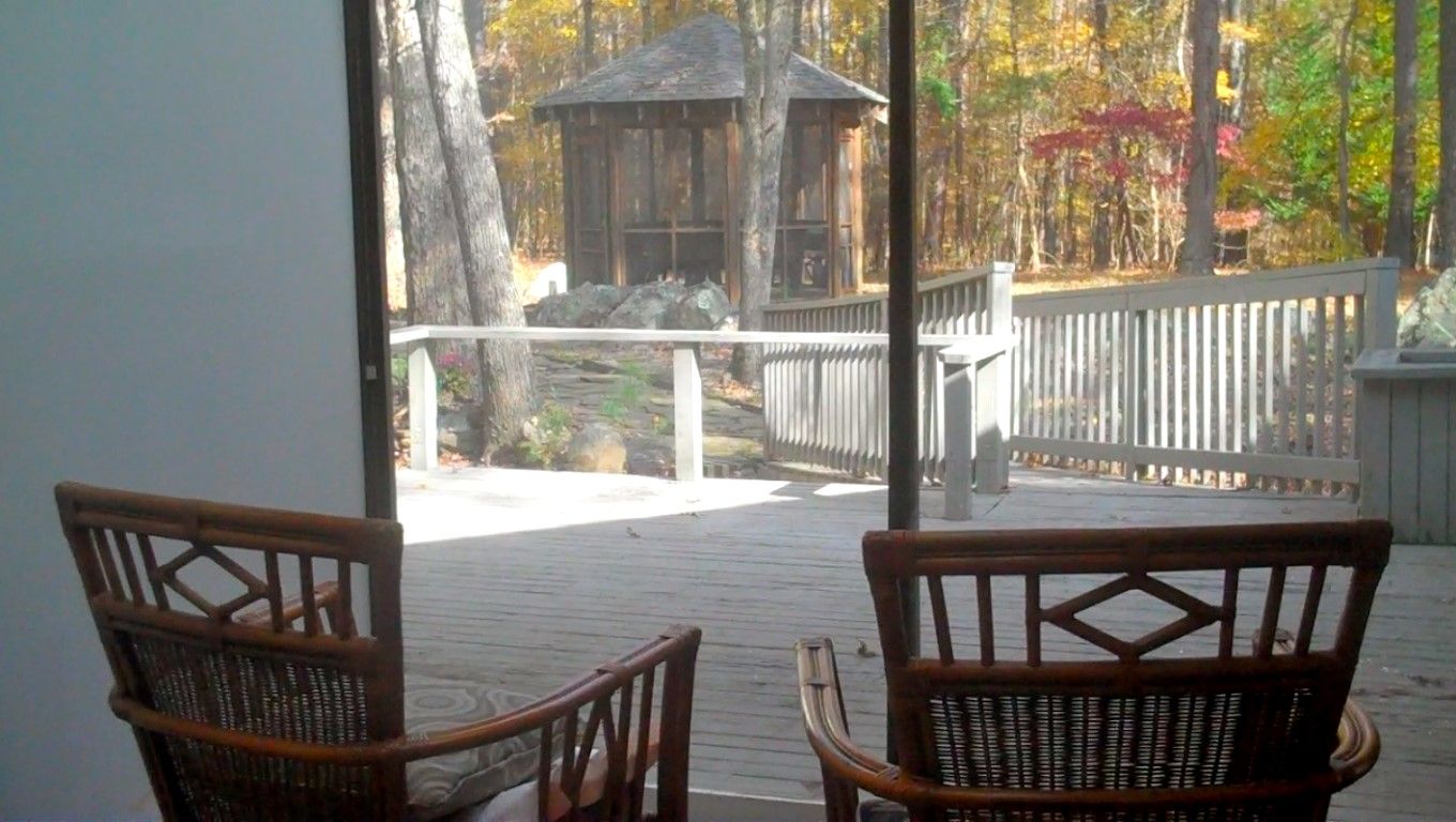 Care Home Corporation DBA LiveWell, assisted living in Chapel Hill, NC — Chairs facing a wooden deck with autumn foliage