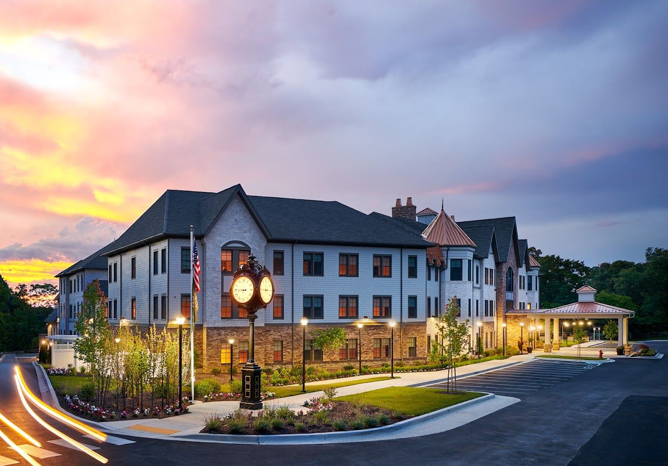 Exterior view of a senior living facility at sunset