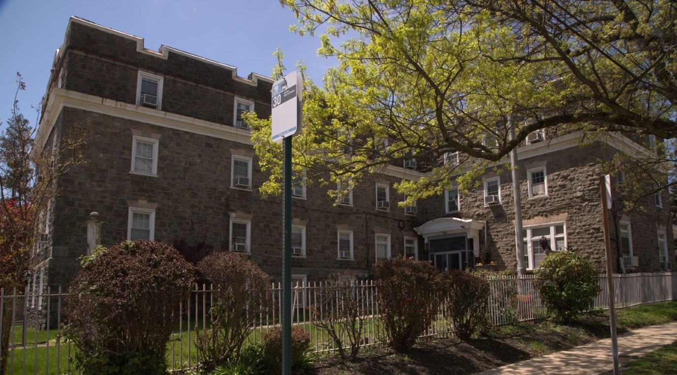 Exterior view of Brittany Manor surrounded by greenery